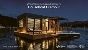 a houseboat clamped to a dock in the water at Houseboat Glamour & wellness in Kaluža +2 photos