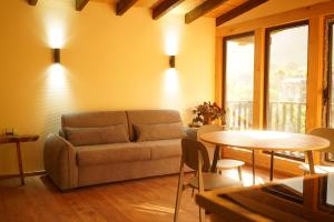 a living room with a couch and a table at Mestia Panorama in Mestia