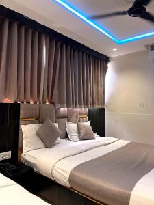 a bedroom with a large bed with a blue light at Hotel prime View in Ahmedabad