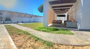 a porch of a house with a couch and a patio at La OSTRA 33 in Chiclana de la Frontera