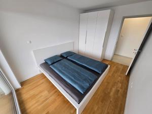 a small white bedroom with a bed in it at Apartma Tri Srca Radenci 3 sobe in Radenci