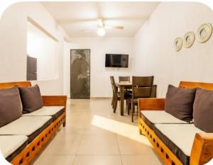 a living room with couches and a dining room at El descanso del guerrero in Barra Vieja