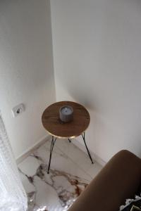 a small table in the corner of a room with a smashed floor at Cloud9 Apartment in Kavála