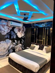 a bedroom with a bed with a wall with flowers at Hotel prime View in Ahmedabad