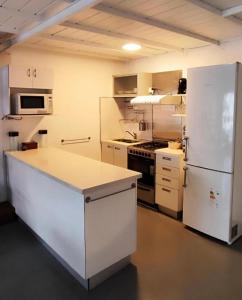 a kitchen with a white refrigerator and a stove at Departamento MOCA - Full Amenities in Buenos Aires