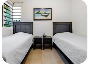 two beds sitting next to each other in a room at El descanso del guerrero in Barra Vieja +14 photos