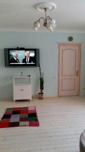 a living room with a flat screen tv on the wall at Eco-Apartment in Province Style in Myrhorod