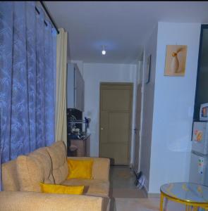 a living room with a couch and a table at Eden Homes in Nairobi