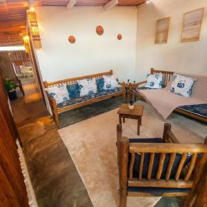 a living room with two beds and a table at Residência Thomas in Itacaré