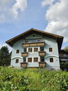 a large white building with wooden balconies at Haus Bergblick in Obertauern