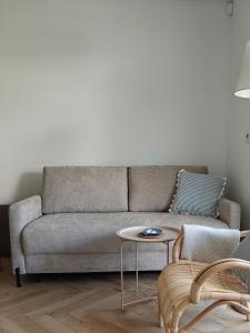a living room with a couch and a table at Brzeg in Kuźnica +37 photos