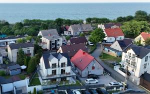 an aerial view of a town with houses and the ocean at Brzeg in Kuźnica