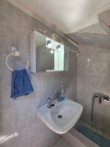 a bathroom with a sink and a mirror at Sidirounta Traditional Home 2 in Chios