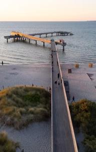 a bridge over a body of water with a pier at Gästehaus am Binnensee in Heiligenhafen