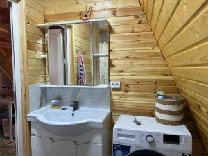 a bathroom with a sink and a washing machine at Esal Rest Zone in Tong +15 photos