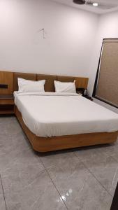 a large bed sitting in a room with at Hotel Dwarkesh in Dwarka