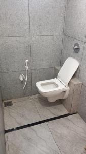 a bathroom with a toilet in a stall at Hotel Dwarkesh in Dwarka