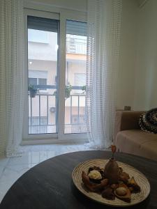 a plate of food on a table in a living room at Cloud9 Apartment in Kavála
