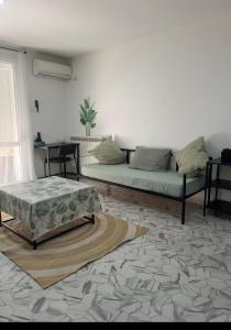 a living room with a couch and a table at Mama house in El Marsa
