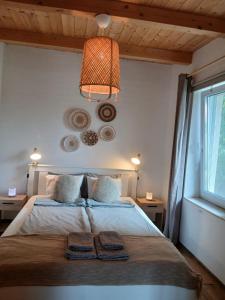 a bedroom with a bed with two towels on it at Vulcanus Apartment in Badacsonytomaj