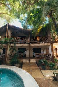 a house with a swimming pool in front of it at Kitecabana Pousada in Cumbuco