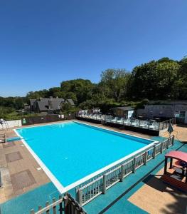 a large blue swimming pool on top of a building at Bracken Lodge in Bucks Mills
