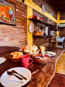 a table with plates of food on top at Hostal del Suri in Cafayate +41 photos