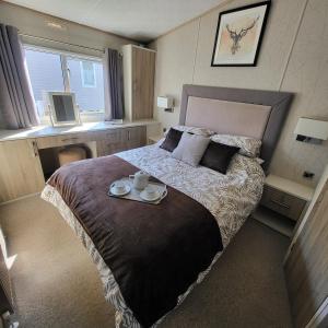 a bedroom with a large bed with two plates on it at Bracken Lodge in Bucks Mills +65 photos