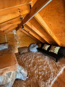 a room with a bed in a wooden attic at Cabaña Palafito in Coelemu