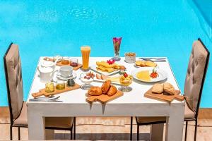 a table with food and drinks on it at Palais Jena Hotel & Spa in Marrakesh