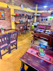 a restaurant with wooden tables and benches in a room at Hostal del Suri in Cafayate