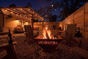 a fire pit in a backyard at night at Romantic Tiny Luxury Retreat w heated pool, sauna n outdoor shower in Wimberley 10 acres in Wimberley