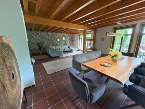 a living room with a wooden table and chairs at Lake House Ternsche in Selm