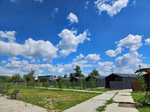 a park with houses and a blue sky with clouds at BAVARO HOTEL and SPA in Oral +1 photo