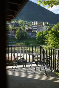 a table and chairs on a balcony with a view at Mestia Panorama in Mestia