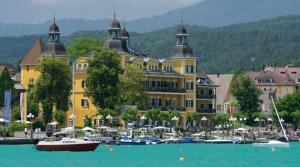 a large yellow building with boats in a harbor at Veldenzer Hammer in Veldenz