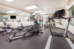 a gym with treadmills and elliptical machines at Wingate by Wyndham Calgary South in Calgary