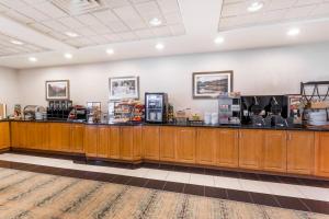 a restaurant with a counter with food on it at Wingate by Wyndham Calgary South in Calgary