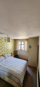 a bedroom with a large bed and a window at Cosy Bungalow in Balbriggan