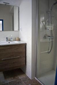 a bathroom with a shower and a sink at Au coeur de Leucate in Leucate