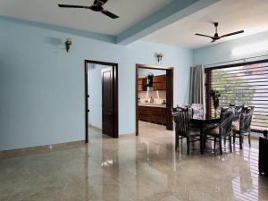 a dining room with a table and chairs at Comfy Corner in Chandīgarh
