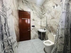 a bathroom with a toilet and a sink at Comfy Corner in Chandīgarh