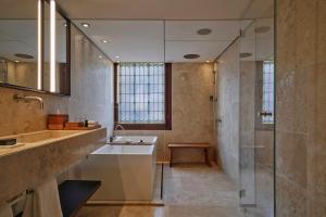 a bathroom with a sink and a glass shower at Mandarin Oriental Conservatorium, Amsterdam in Amsterdam +135 photos