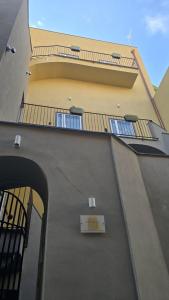 a building with balconies and a box on the side at Casa Vacanza Palazzo Monacelli 1 in Torre del Greco