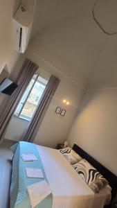 a bedroom with a large bed in a attic at Casa Vacanza Palazzo Monacelli 1 in Torre del Greco