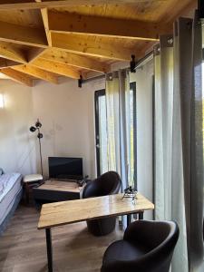 a living room with a wooden table and chairs at Agroturystyka Rajski Ogród in Mysłakowice
