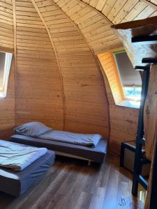 a room with two beds in a dome shaped room at Agroturystyka Rajski Ogród in Mysłakowice
