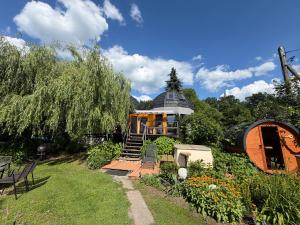 a house in a garden with a pathway leading to it at Agroturystyka Rajski Ogród in Mysłakowice +7 photos