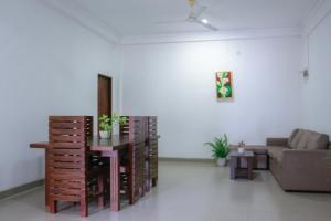 a living room with a couch and a table at Prabha Garden Boutique Villa in Anuradhapura +57 photos
