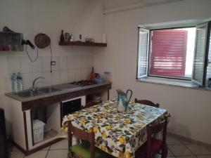 a kitchen with a table with a table cloth on it at Fosso Marchese in Cusano Mutri